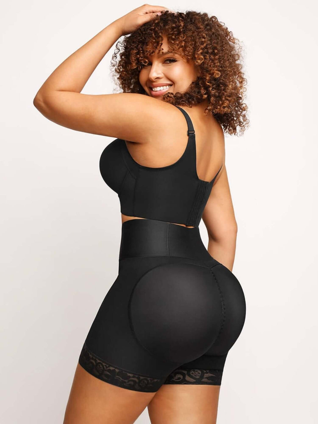 High-waisted shaping shorts with back support and smoothing fit for all-day comfort, shown on model in black