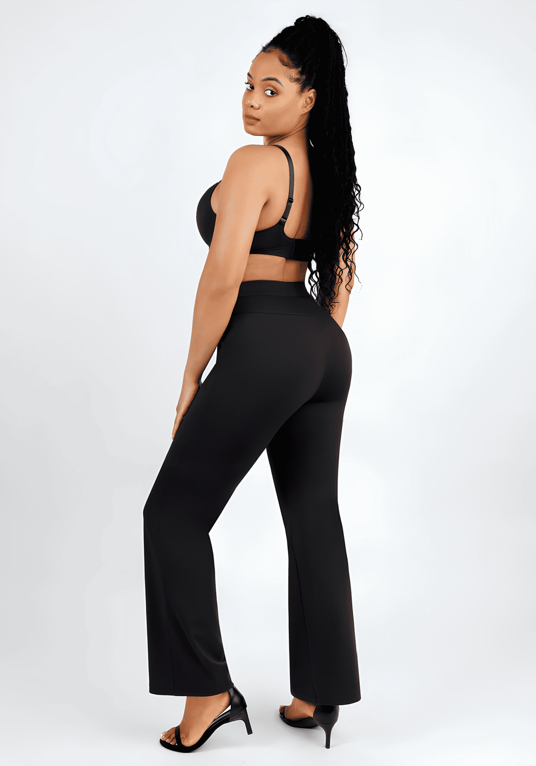 High-waisted straight leg pants with sculpting fit, black wide-leg style on model