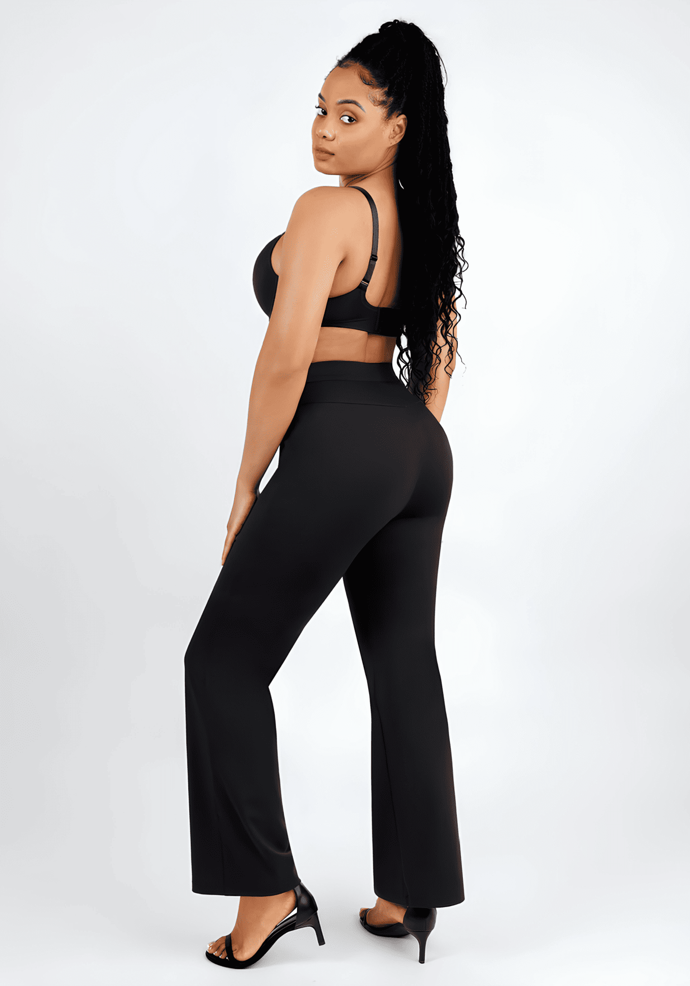 High-waisted straight leg pants with sculpting fit, black wide-leg style on model