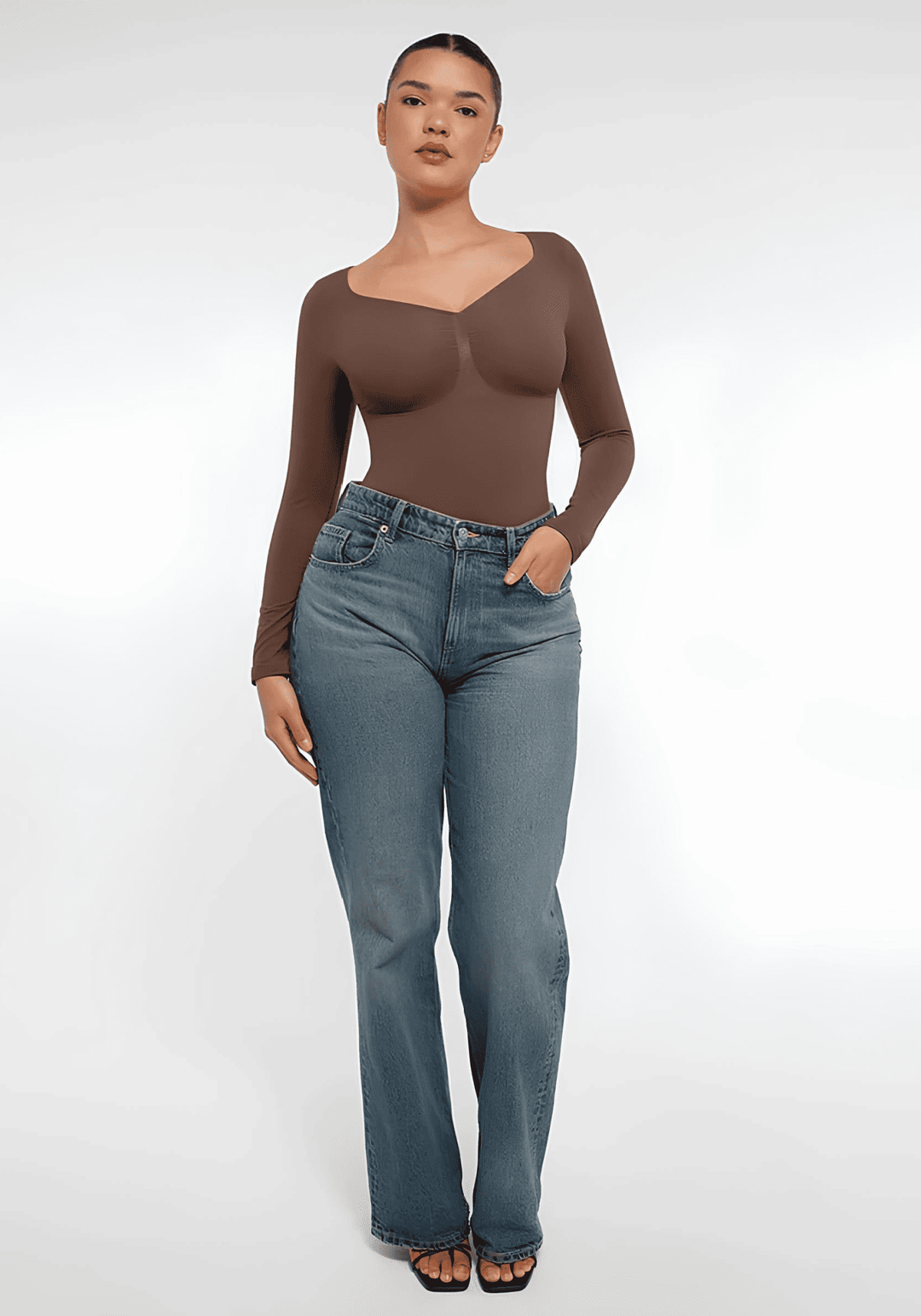 long sleeve sculpting bodysuit in brown seamless shapewear styled with jeans for a smooth, sculpted silhouette