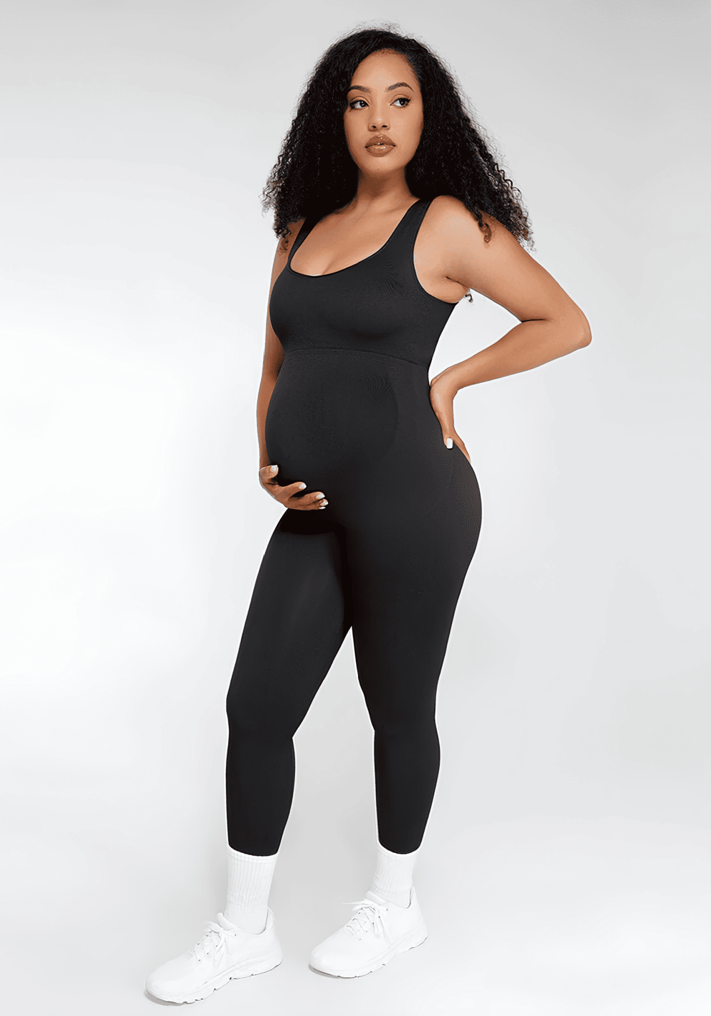 Maternity catsuit in black with square neck, tank straps, built-in shelf bra, and stretchy bump-friendly fit