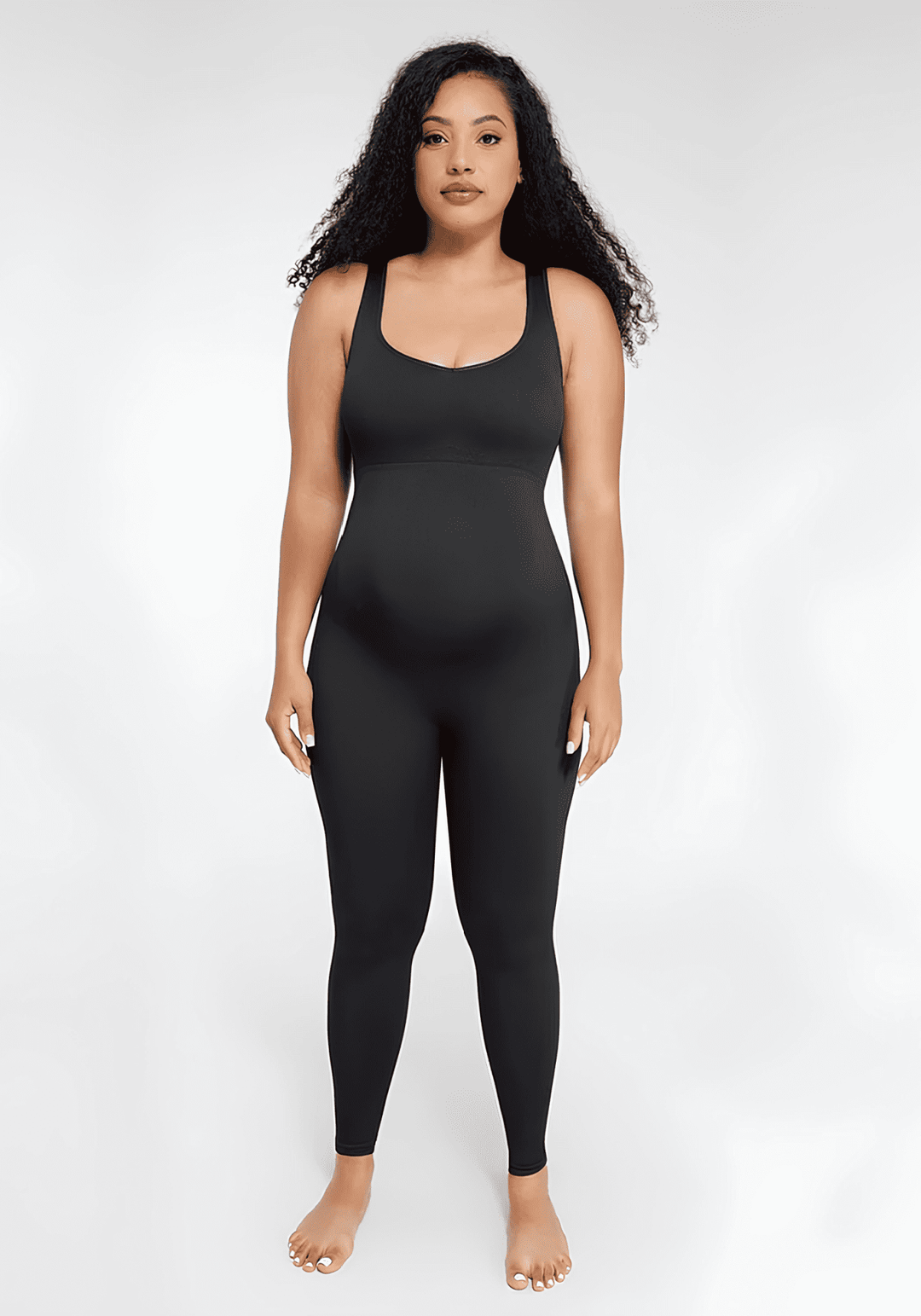 Maternity catsuit in black with square neck, tank straps, built-in shelf bra, and a flattering second-skin fit.