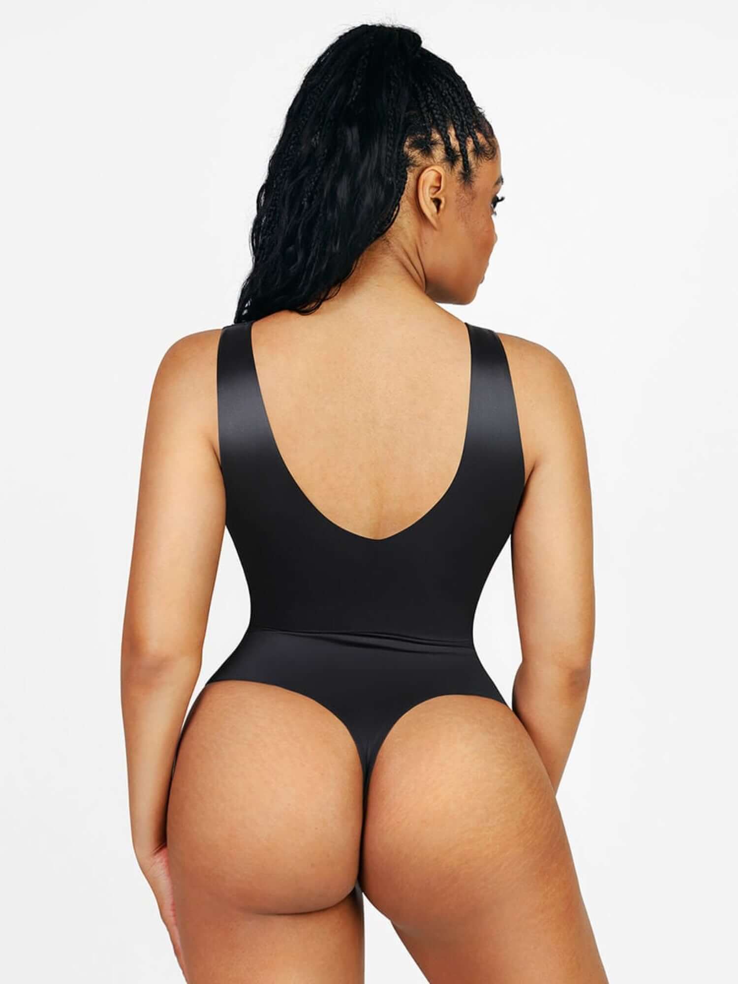 satin v-neck bodysuit with deep low-cut back, figure-enhancing fit, and smooth satin finish on model