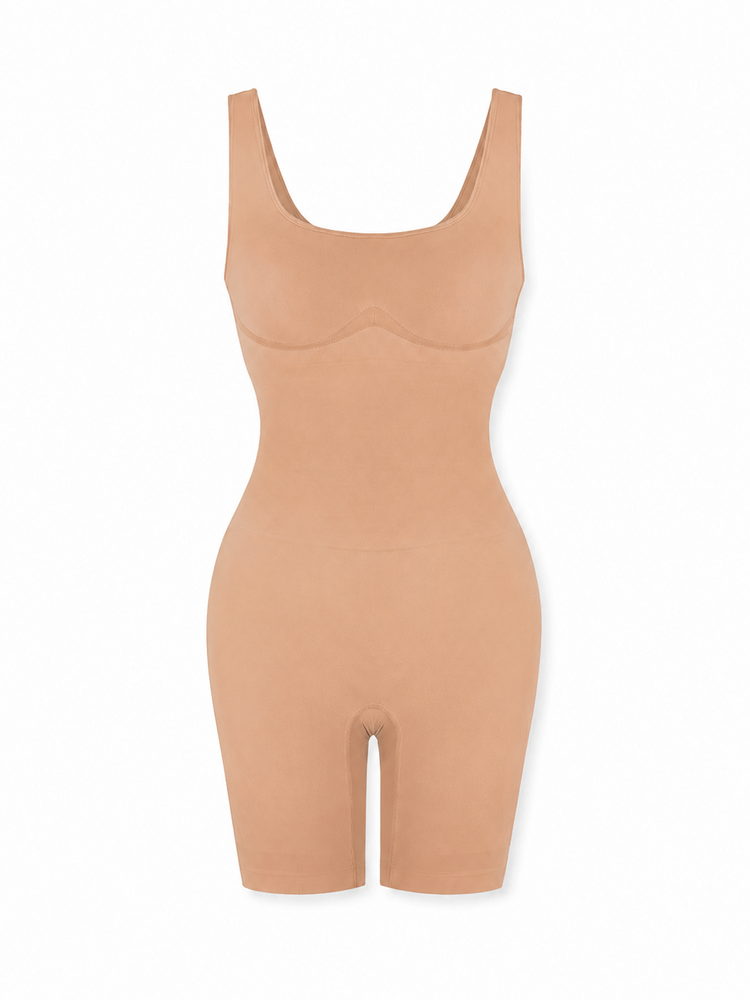 A beige shapewear bodysuit with a scoop neckline and short legs, shown on a plain white background.