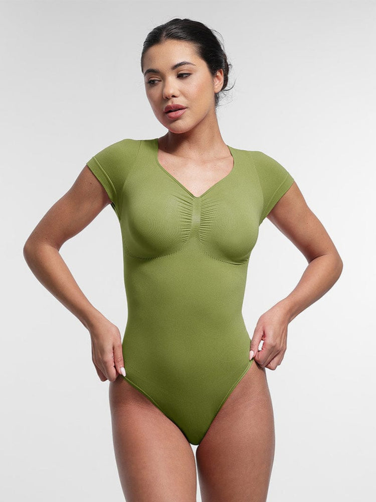 Woman wearing a green one-piece swimsuit on a white background