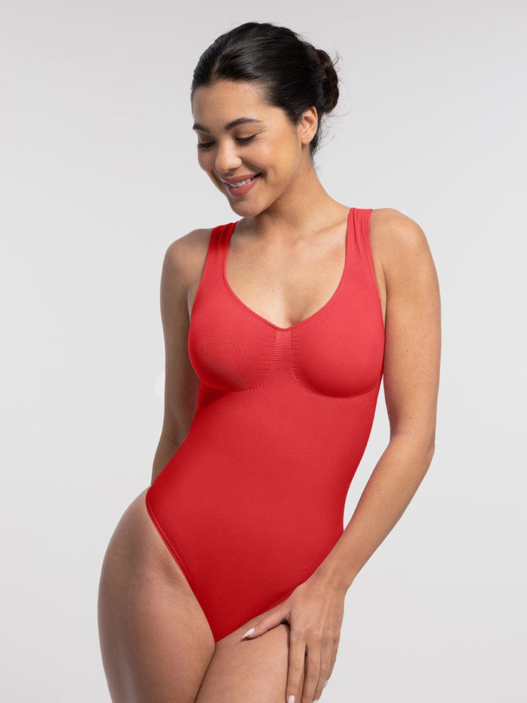 Woman wearing a red swimsuit against a plain background