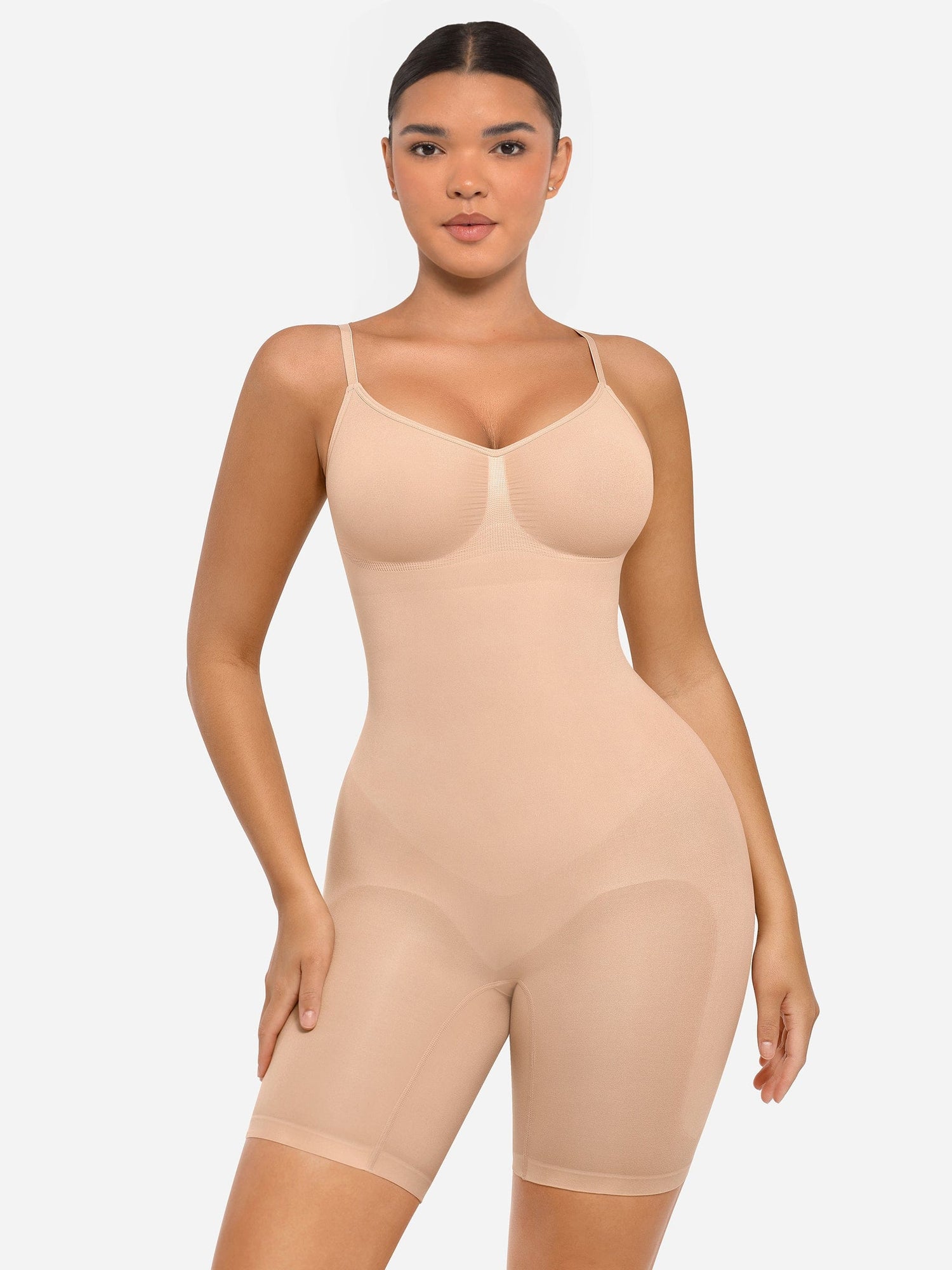 Woman wearing a beige shapewear garment on a white background