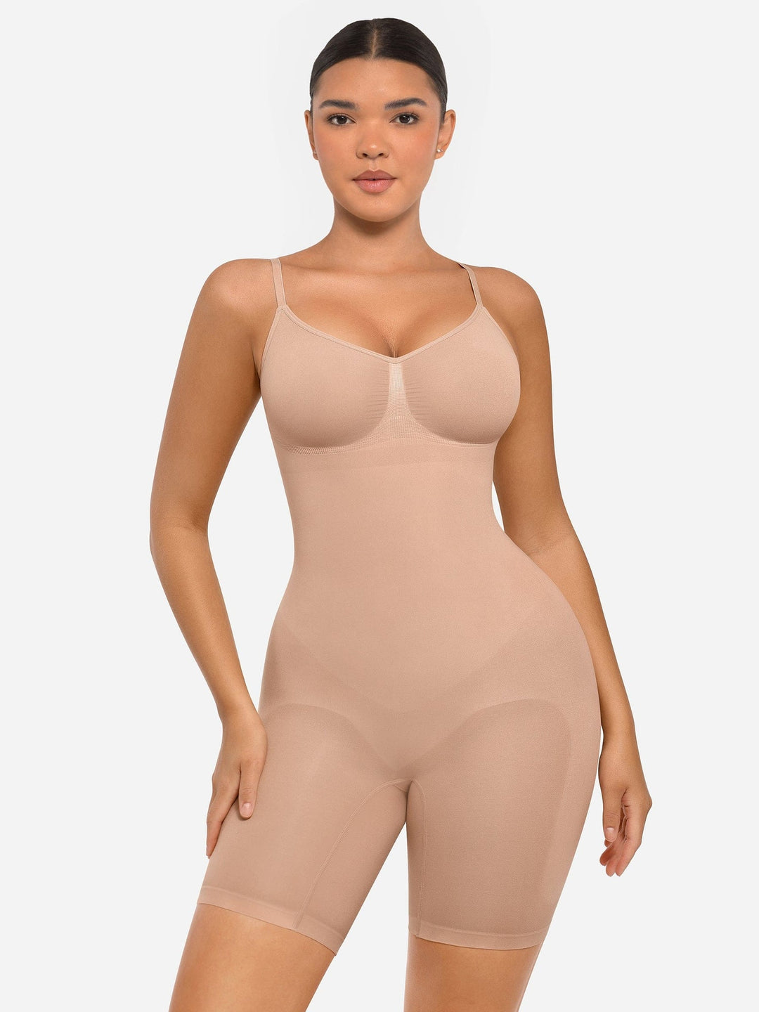 Woman wearing a beige shapewear bodysuit on a white background