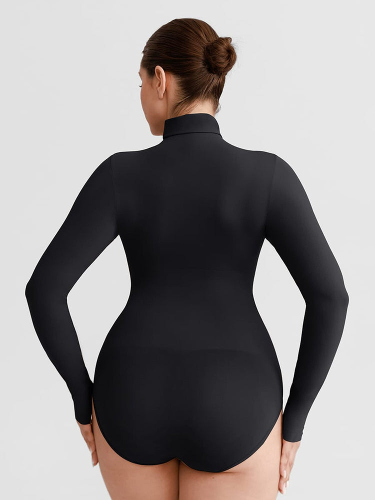 A woman shown from the back wearing a black long-sleeve mock-neck bodysuit or shapewear garment against a light gray studio background.