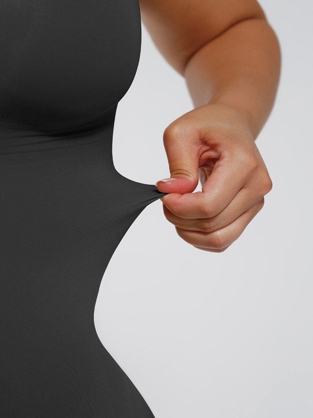 Close-up showing stretch of the bodysuit fabric