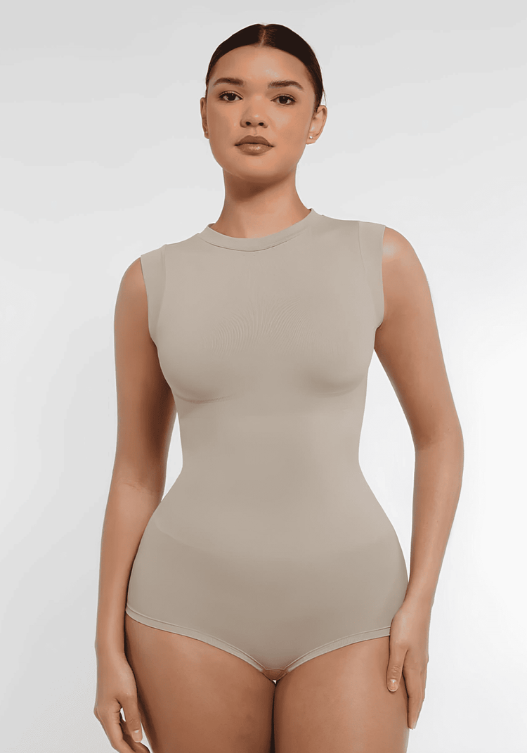 Beige seamless shaping bodysuit with high neck, cap sleeves, and waist-sculpting fit for a sleek silhouette.