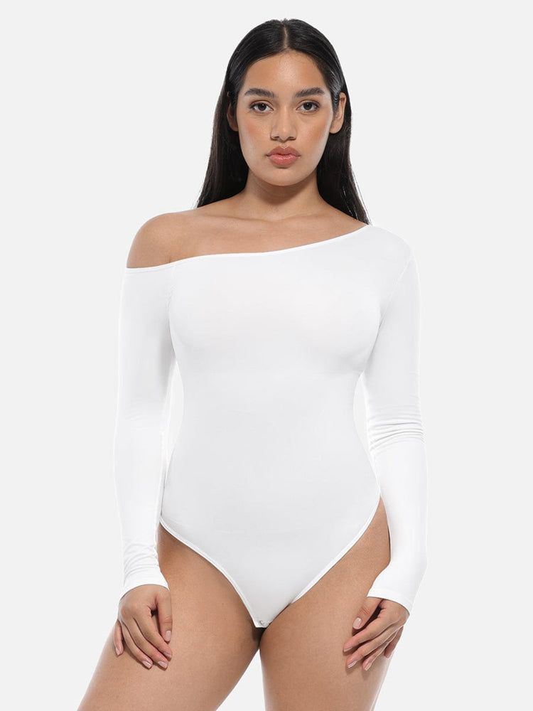Woman wearing a white off-shoulder bodysuit on a plain background