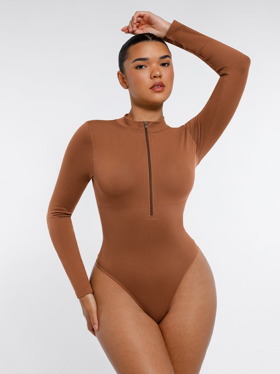 Woman wearing a brown bodysuit against a white background