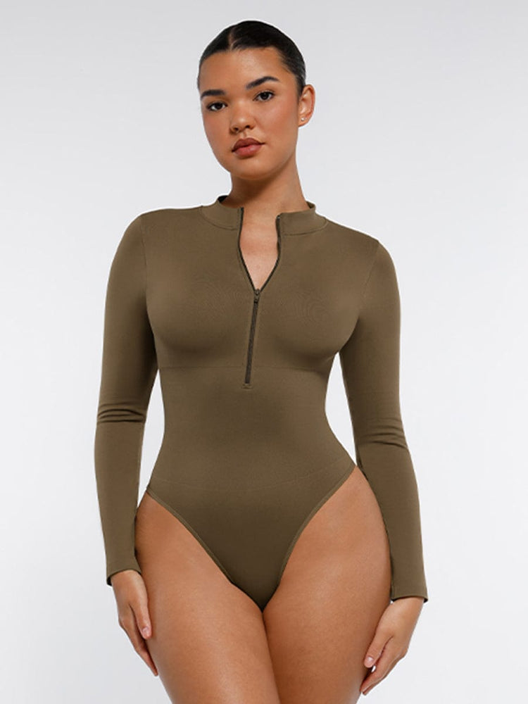 Woman wearing a brown long-sleeve bodysuit with a zipper on a white background