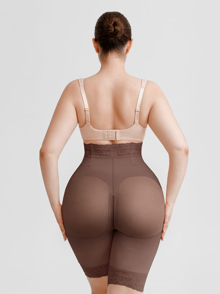 Rear view of a woman modeling high-waisted shapewear briefs in a dark brown shade, paired with a matching beige bra, against a light gray studio background.