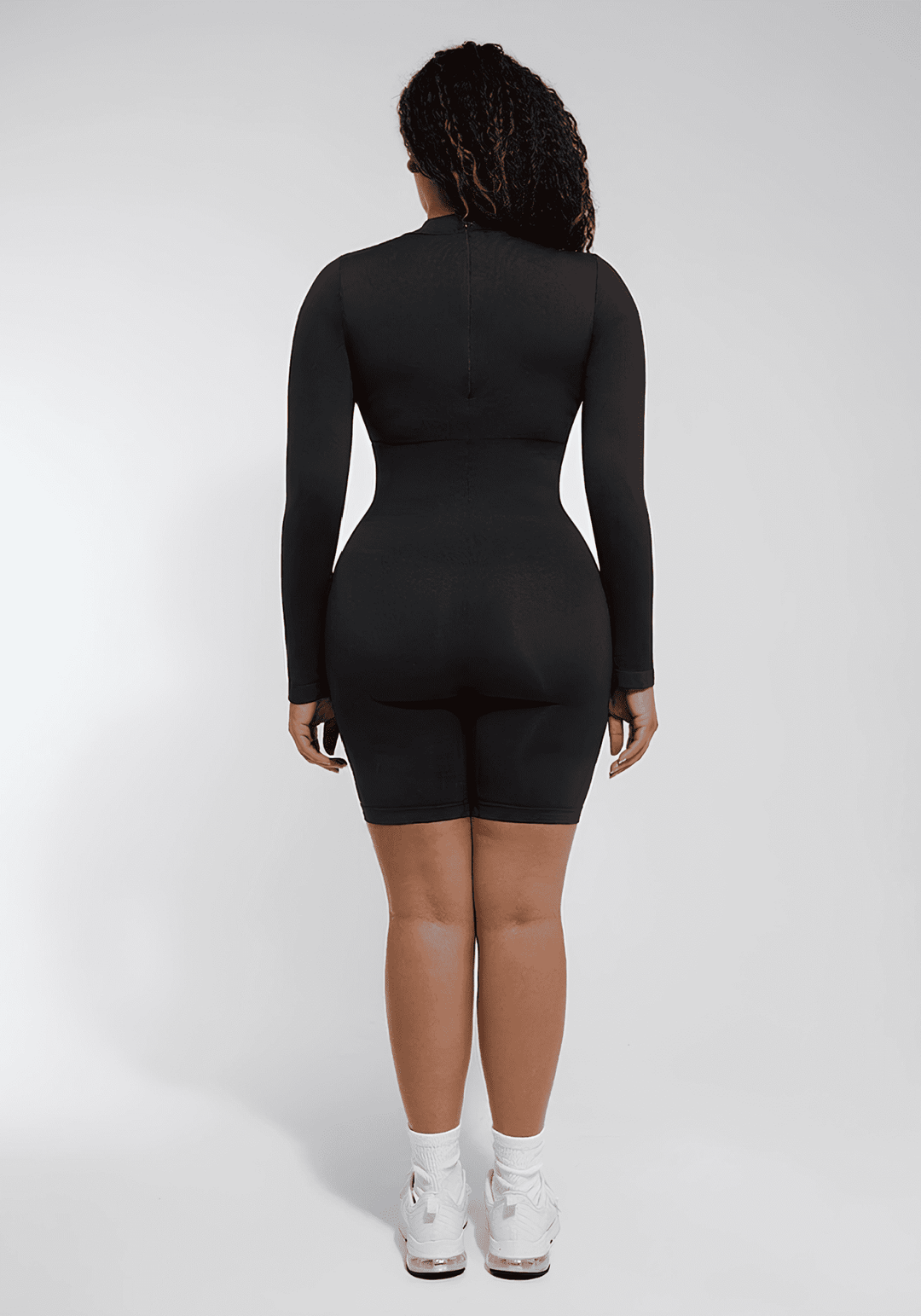tummy control bust support jumpsuit black seamless back view with long sleeves and body-hugging fit