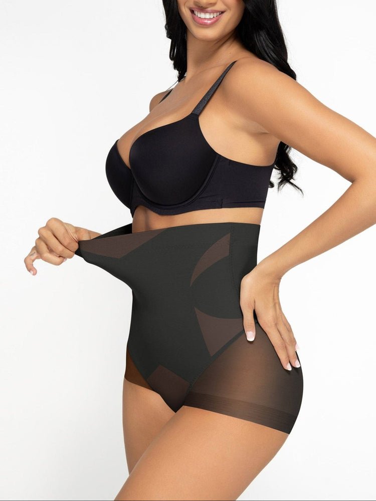 Woman wearing a black bra and high-waisted shapewear on a white background