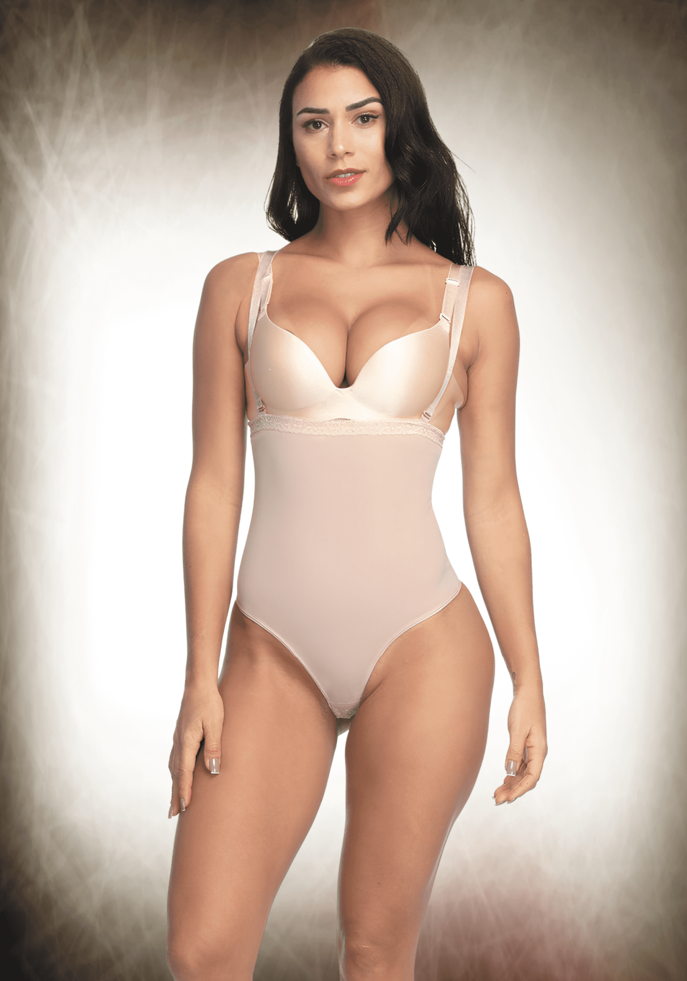 Underbust shapewear bodysuit with adjustable straps, open bust, tummy control, and thong design for a smooth silhouette.